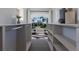 Custom closet with view features shelving and rods, offering a glimpse of the beautiful property and landscaping at 367 W Royal Flamingo Dr, Sarasota, FL 34236