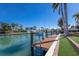 This waterfront home has a private dock with a boat lift, ladder, and stunning views of the canal at 367 W Royal Flamingo Dr, Sarasota, FL 34236