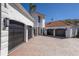 Spacious home with attached garages, a brick driveway, and a well-maintained exterior, offering ample parking space at 367 W Royal Flamingo Dr, Sarasota, FL 34236