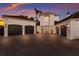 Elegant home showcasing a multi-car garage, paver driveway, beautiful columns and manicured landscaping, exuding curb appeal at 367 W Royal Flamingo Dr, Sarasota, FL 34236