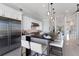 Modern kitchen featuring a long breakfast bar, stainless steel appliances, and white cabinetry at 367 W Royal Flamingo Dr, Sarasota, FL 34236