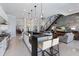 Spacious open kitchen with a large island, bar seating, stainless steel appliances, and modern lighting at 367 W Royal Flamingo Dr, Sarasota, FL 34236