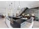 Modern open-concept kitchen and living room with floating stairs, marble wall, and luxury finishes at 367 W Royal Flamingo Dr, Sarasota, FL 34236