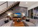 Modern living room with comfortable seating, stylish decor, and a staircase leading to the upper level at 367 W Royal Flamingo Dr, Sarasota, FL 34236