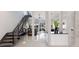 Open-concept living room with staircase, modern lighting, neutral color palette, and expansive views at 367 W Royal Flamingo Dr, Sarasota, FL 34236