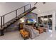 Comfortable living area with large grey accent wall, staircase, and a view of the backyard and pool at 367 W Royal Flamingo Dr, Sarasota, FL 34236