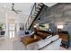 Comfortable living room featuring a modern staircase and a decorative stone accent wall at 367 W Royal Flamingo Dr, Sarasota, FL 34236