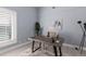Bright office space with a large window, modern desk, stylish decor, and light gray walls at 367 W Royal Flamingo Dr, Sarasota, FL 34236