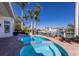 Inviting backyard pool area with spa, lush landscaping, and waterfront views at 367 W Royal Flamingo Dr, Sarasota, FL 34236