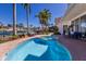 Backyard with pool and views of canal surrounded by brick patio, palm trees, lush landscaping and water views at 367 W Royal Flamingo Dr, Sarasota, FL 34236