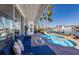 Inviting patio with a kidney-shaped pool, lush landscaping, and comfortable seating overlooking the waterfront at 367 W Royal Flamingo Dr, Sarasota, FL 34236
