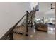 Modern staircase with sleek metal railings and wood steps leading to the upper level at 367 W Royal Flamingo Dr, Sarasota, FL 34236
