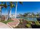 Scenic waterfront property with lush landscaping, palm trees, and private dock at 367 W Royal Flamingo Dr, Sarasota, FL 34236
