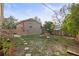 Landscaped backyard with patio and small building at 4704 Town N Country Blvd, Tampa, FL 33615