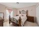 Bedroom with ornate bed frame and wood dresser at 4704 Town N Country Blvd, Tampa, FL 33615