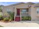 House exterior featuring red door and landscaping at 4704 Town N Country Blvd, Tampa, FL 33615