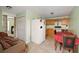 Efficient kitchen with wood cabinets, refrigerator, and dining area at 4704 Town N Country Blvd, Tampa, FL 33615