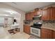 Kitchen features wood cabinets, tile backsplash, and view of dining area at 4704 Town N Country Blvd, Tampa, FL 33615