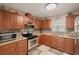 Kitchen featuring wood cabinets, granite counters, and stainless steel appliances at 4704 Town N Country Blvd, Tampa, FL 33615