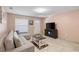 Living room with L-shaped sofa, coffee table, and TV at 4704 Town N Country Blvd, Tampa, FL 33615