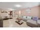 Open living space with L-shaped sofa and dining area at 4704 Town N Country Blvd, Tampa, FL 33615