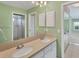 Double sink bathroom with a shower and built in cabinets at 5607 Garden Lakes Majestic, Bradenton, FL 34203
