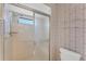 Shower stall with glass enclosure and patterned wallpaper at 5607 Garden Lakes Majestic, Bradenton, FL 34203