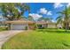 Single-story home with attached garage and lush lawn at 5607 Garden Lakes Majestic, Bradenton, FL 34203