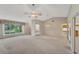 Bright living room with high ceilings and multiple access points at 5607 Garden Lakes Majestic, Bradenton, FL 34203