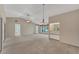 Open concept living area with access to sunroom and kitchen at 5607 Garden Lakes Majestic, Bradenton, FL 34203