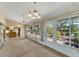 Spacious sunroom with multiple access points and views of the surrounding landscape at 5607 Garden Lakes Majestic, Bradenton, FL 34203