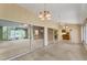 Bright sunroom showcasing views into the kitchen and backyard at 5607 Garden Lakes Majestic, Bradenton, FL 34203