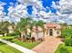 Single-story home with brick paver driveway and lush landscaping at 5835 Benevento Dr, Sarasota, FL 34238