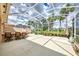 Large screened patio with outdoor kitchen and seating at 5835 Benevento Dr, Sarasota, FL 34238