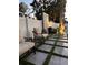 This outdoor shower area is surrounded by decorative landscaping and a white fence at 5906 Larchwood Ave, Sarasota, FL 34231