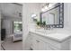 Clean bathroom with white vanity, large mirror and in-unit laundry at 6308 Lilac Pl, Sarasota, FL 34231