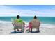 Couple relaxing in beach chairs overlooking the ocean at 6308 Lilac Pl, Sarasota, FL 34231