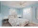 Bedroom with light blue walls and floral bedding at 6308 Lilac Pl, Sarasota, FL 34231