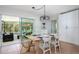 Light and airy dining room with sliding glass doors leading to the pool at 6308 Lilac Pl, Sarasota, FL 34231