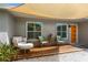 Inviting front porch with shaded seating area and modern decor at 6308 Lilac Pl, Sarasota, FL 34231