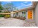 Home exterior with orange door and patio seating at 6308 Lilac Pl, Sarasota, FL 34231