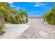 Bright front yard with palm trees and brick driveway at 6308 Lilac Pl, Sarasota, FL 34231