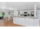 Bright kitchen with white cabinets, granite counters, and breakfast bar at 6308 Lilac Pl, Sarasota, FL 34231