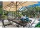 Outdoor patio with table, chairs, and umbrella, perfect for dining al fresco at 6308 Lilac Pl, Sarasota, FL 34231
