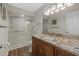 Bathroom featuring granite countertops, light-colored walls, wood-look floors, a walk-in shower, and neutral tiling at 7207 Oak Moss Dr # 63, Sarasota, FL 34241