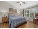 Comfortable bedroom with neutral walls, wood-look flooring, and views of the backyard at 7207 Oak Moss Dr # 63, Sarasota, FL 34241
