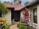 Inviting home entrance with terracotta tile roof and lush, well-maintained landscaping at 7207 Oak Moss Dr # 63, Sarasota, FL 34241
