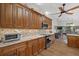 Spacious kitchen featuring wood cabinets, granite counters, stainless steel appliances, and wood-look flooring at 7207 Oak Moss Dr # 63, Sarasota, FL 34241
