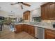 Bright kitchen featuring custom cabinetry, stainless steel appliances, and stone countertops at 7207 Oak Moss Dr # 63, Sarasota, FL 34241