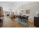 Open-concept living area flows to the dining space, creating a bright and inviting space with wood floors and ample light at 7207 Oak Moss Dr # 63, Sarasota, FL 34241
